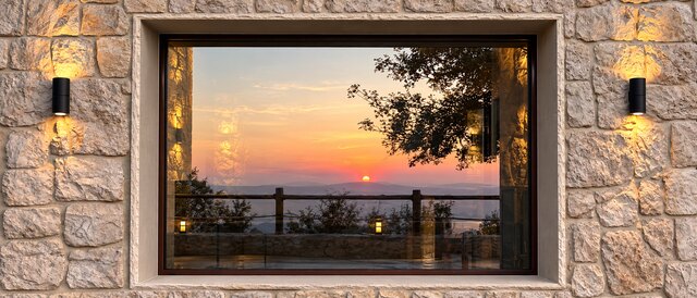 La Grande's picture window at dusk, the valley catching the last light through the glass.