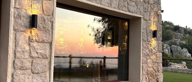 La Grande's picture window at dusk, the valley catching the last light through the glass.